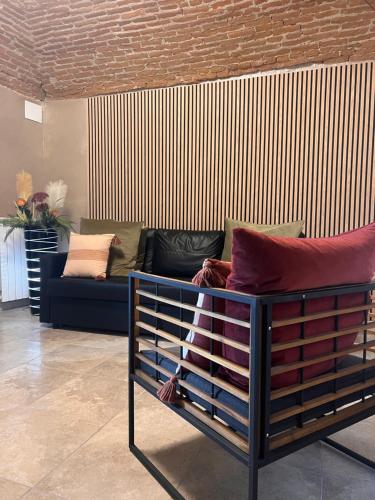 a bed in a living room with a couch at Le camere del Cappello Verde in Ivrea