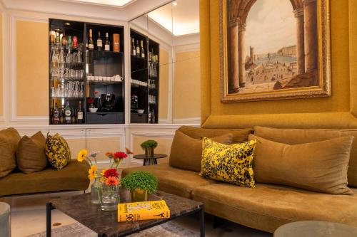 a living room with a couch and a table at Hôtel Le Regent Paris in Paris