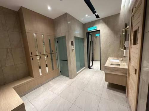 a large bathroom with two sinks and a walk in shower at Maxhome at Axon Bukit Bintang in Kuala Lumpur