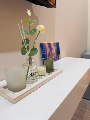 a tray with a vase and candles on a table at Villa Merkuri in Himare