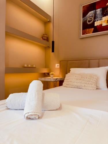a bedroom with two beds with towels on them at Villa Merkuri in Himare