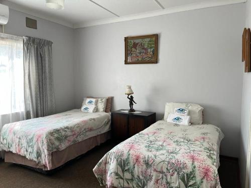 Ένα ή περισσότερα κρεβάτια σε δωμάτιο στο Elwandle Guest House