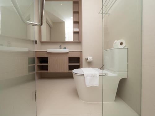 a bathroom with a toilet and a sink at 2Bd with 2Bt Apt in Skypark Laguna Bang tao in Phuket Town