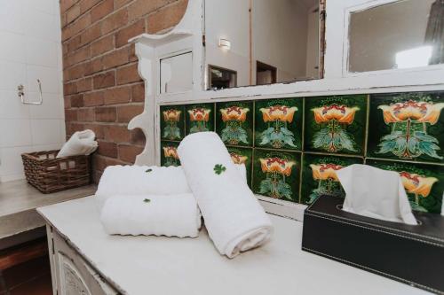 a bathroom with towels sitting on a counter at Upington African Vineyard Boutique Hotel & SPA in Kanoneiland