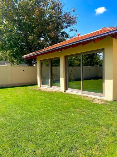 a house with large windows in a yard at CONFORT HOUSE in Lugoj