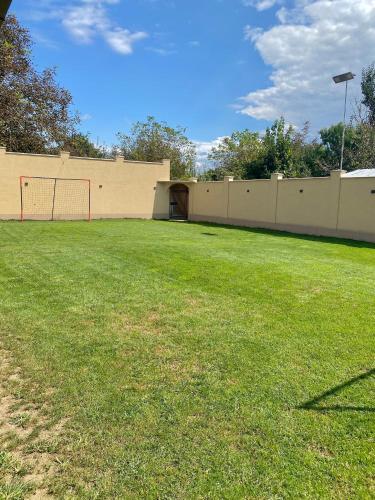 a field with a fence and a soccer goal at CONFORT HOUSE in Lugoj