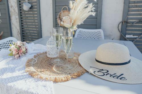 a table with a straw hat and glasses on it at Casa Palfy in Oslip