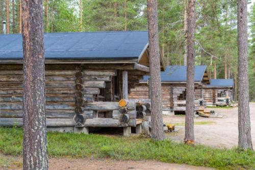a log cabin in the woods with trees at Holiday Village Himmerki in Posio