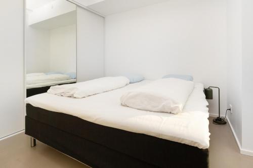 a bedroom with two beds and a mirror at Come Stay 50 meter til vand, plads til 6-personer in Aarhus