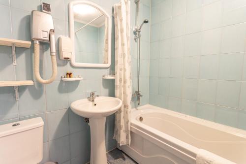 a bathroom with a sink and a toilet and a bath tub at Čill Easy hotel with self check-in in Ādaži