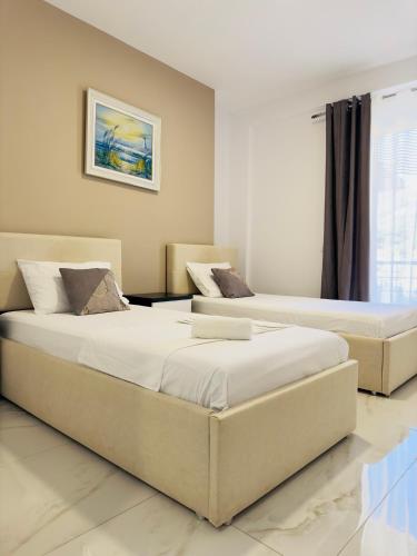 two beds sitting next to each other in a bedroom at Villa Merkuri in Himare