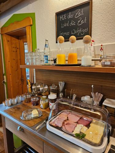 a counter top with a tray of meat and cheese at Pension Schatzkisterl in Zwiesel