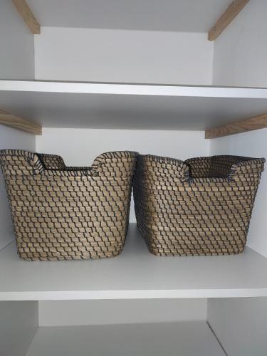 two pillows sitting on a shelf in a room at Appartement SERENITE, tout confort 2adultes 1 enft in Les Trois-Îlets
