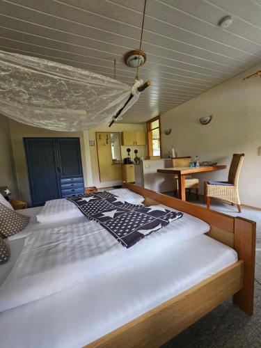 a bedroom with a large white bed in a room at Pension Schatzkisterl in Zwiesel