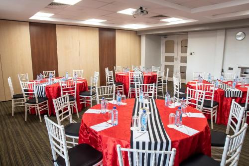 a conference room with red and white tables and chairs at Executive Residency by Best Western Nairobi in Nairobi