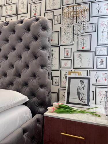 a bedroom with a bed and a table with a laptop at Maison 31 -Luxury Apartments in Santa Marinella