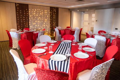 a conference room with red and white tables and chairs at Executive Residency by Best Western Nairobi in Nairobi