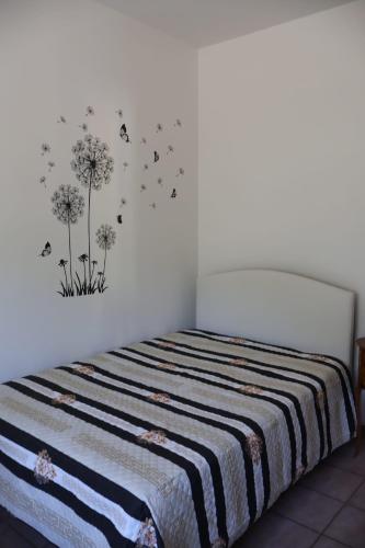 a bedroom with a bed with dandelions on the wall at B&b Mamì in Potenza