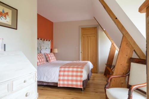 a bedroom with a bed and a stair case at Le Domaine de Ravenoville - Pierres d'Histoire in Ravenoville