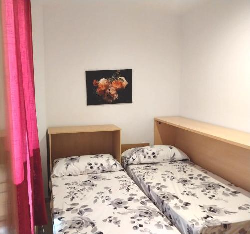 a room with two beds and a picture on the wall at La Casella playa de Gandia in Playa de Gandia