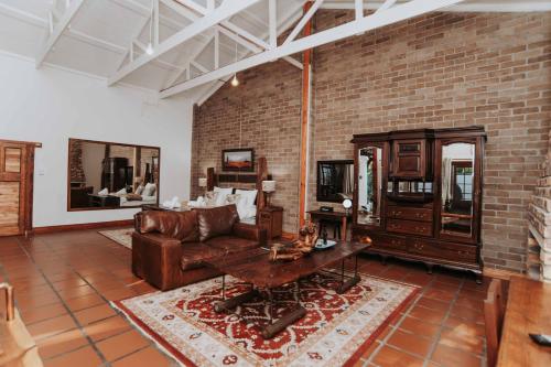 a living room with a couch and a table at Upington African Vineyard Boutique Hotel & SPA in Kanoneiland