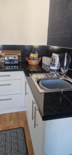 a kitchen with a sink and a counter top at Hillend Self-Catering in Portree