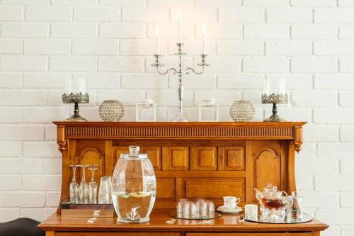 a table with glasses and a bottle on it at Upington African Vineyard Boutique Hotel & SPA in Kanoneiland