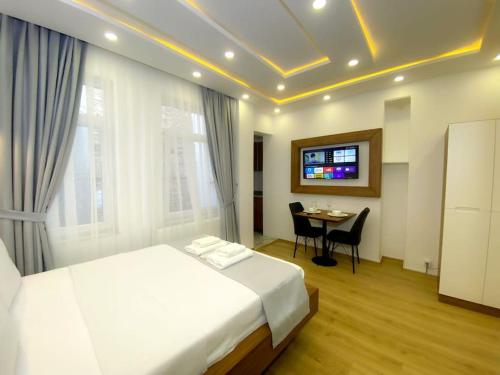 a bedroom with a bed and a table and a television at İSLAND APARTİSTANBUL in Istanbul