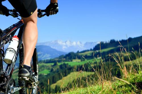 a person riding a bike on a grassy hill at Haus Schönblick in Kirchberg in Tirol