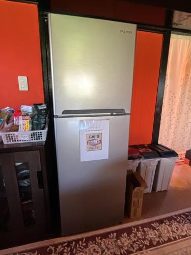 a refrigerator with a sticker on it in a kitchen at Airport Osaka in Kaizuka