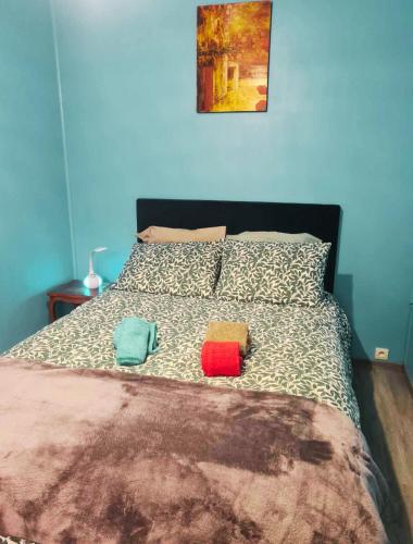 a bed with two pillows and two towels on it at Home Sweet Home in Bouglainval