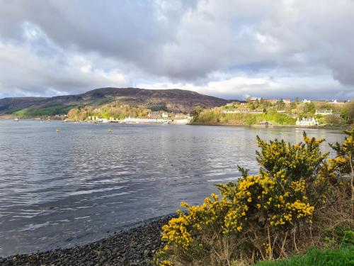 a view of a body of water with mountains in the background at Hillend Self-Catering in Portree