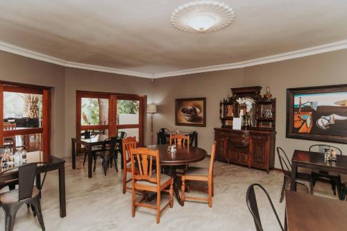 a dining room with a table and chairs at Upington African Vineyard Boutique Hotel & SPA in Kanoneiland
