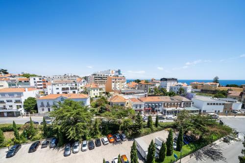 a view of a city with cars parked in a parking lot at Palácio Estoril Hotel, Golf & Wellness in Estoril