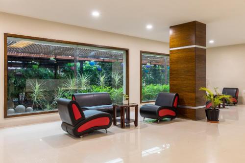 a waiting room with two chairs and a table at Monk's Nirvanaa Hotel & Resort in Indore