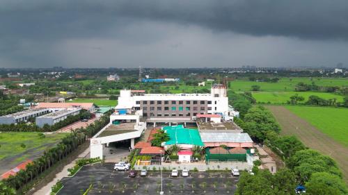 an overhead view of a building with a green field at Monk's Nirvanaa Hotel & Resort in Indore