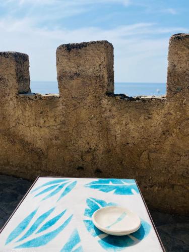 a plate sitting on a table next to a wall at Idillioravello in Ravello
