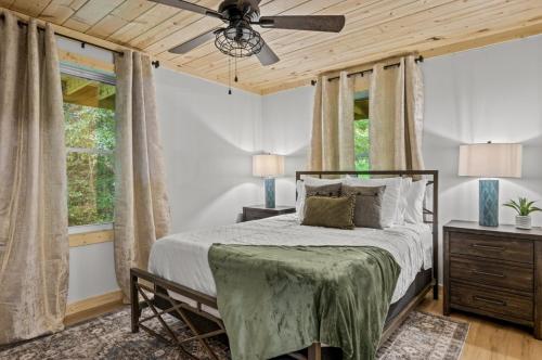 a bedroom with a bed and a ceiling fan at Hidden Forest Spa Sauna Nature Secluded 93 acres in Sevierville