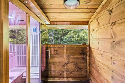 a room with a wooden wall and a window at Hidden Forest Spa Sauna Nature Secluded 93 acres in Sevierville