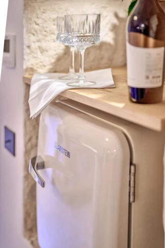 a bottle of wine and a wine glass on a counter at Bambarone La Masseria in Fasano
