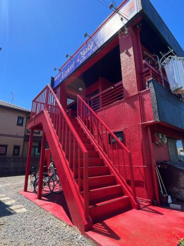a red staircase on the side of a red building at Airport Osaka in Kaizuka