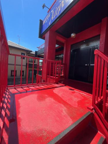 a red balcony of a building with a red floor at Airport Osaka in Kaizuka
