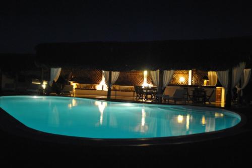 a large blue swimming pool at night at Villa Palissandre in Nosy Be