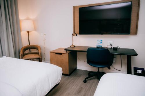 a hotel room with a desk and a tv at Fairfield Inn & Suites by Marriott Lexington Georgetown/College Inn in Georgetown