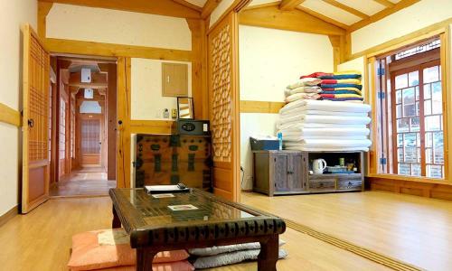 a living room with a table and a stack of plates at Hwangnamguan Hanok Village in Gyeongju
