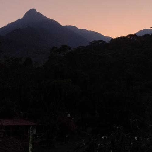 a view of a mountain at sunset at Sapiens house cabaña del lago clásica in Cali