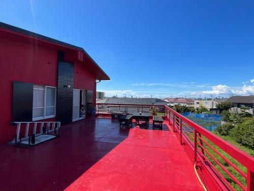 a red deck with a table and benches on a building at Airport Osaka in Kaizuka