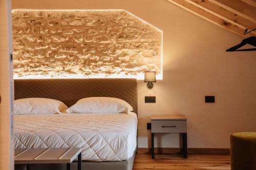 a bedroom with a bed with a white comforter at Ca'Lisel in Valdobbiadene