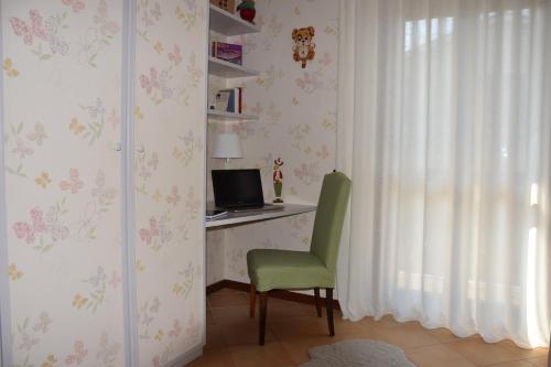 a room with a desk with a computer and a chair at Casa Palmira in Pescocostanzo