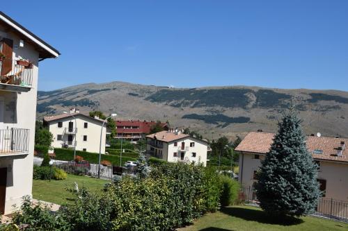 a city with houses and a christmas tree and a mountain at Casa Palmira in Pescocostanzo
